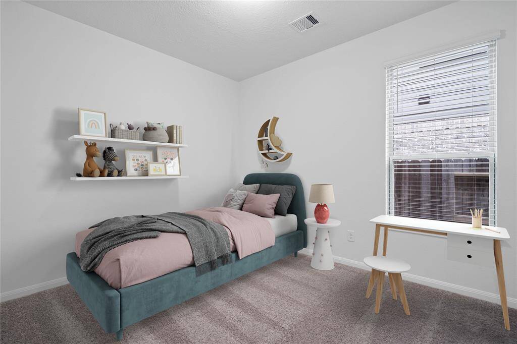 Secondary bedroom features plush carpet, custom paint, large window with privacy blinds and ample closet space.