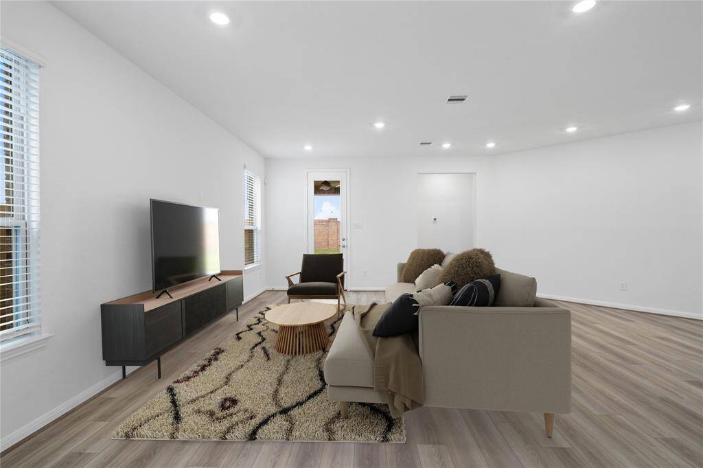 Gather the family and guests together in your lovely family room! Featuring high ceilings, recessed lighting, custom paint, gorgeous vinyl plank floors and large windows with blinds that provide plenty of natural lighting throughout the day.