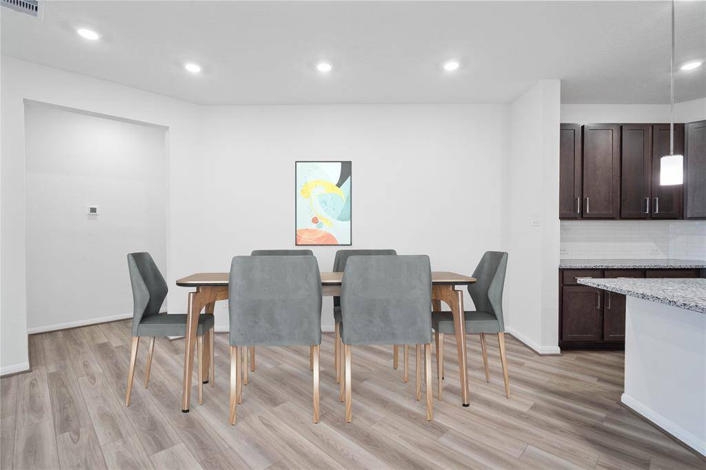 Start your day off right with a cup of coffee sitting with your family in the lovely dining area! Featuring custom paint, vinyl plank flooring, and wonderful access to the gorgeous kitchen.
