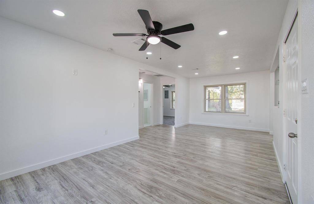 Spacious open-concept living room with seamless flow, modern finishes, and abundant natural light.