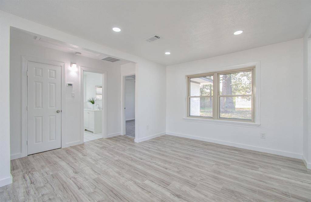 Spacious open-concept living room with seamless flow, modern finishes, and abundant natural light.