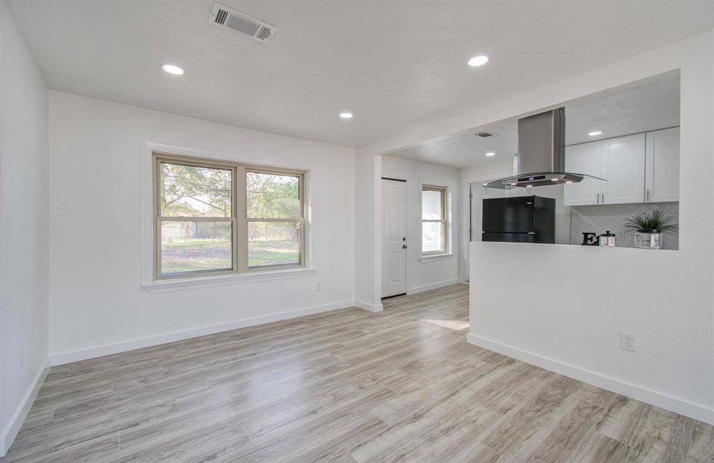 Bright open-concept living room with modern design and ample natural light.