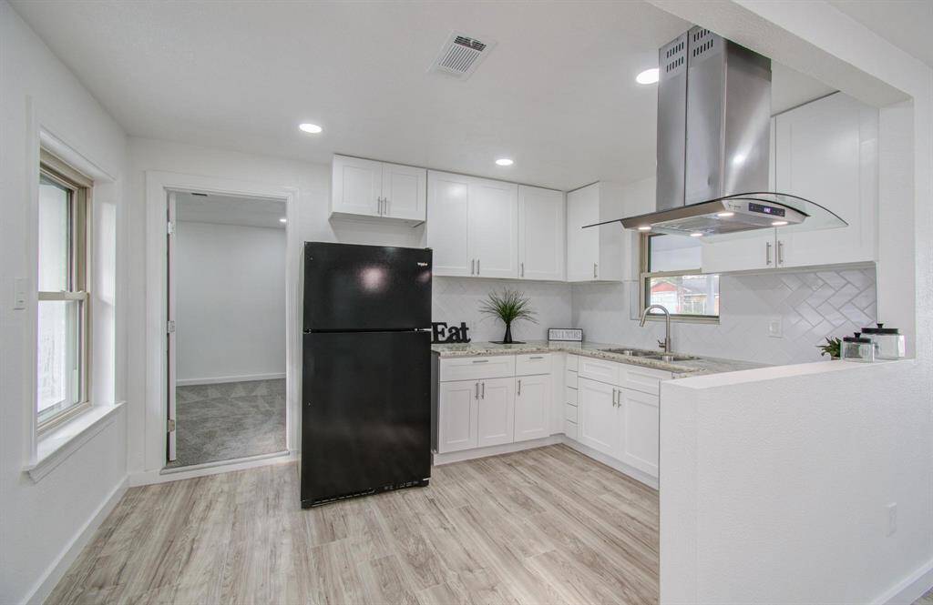 Modern kitchen with sleek countertops, ample storage, and contemporary finishes