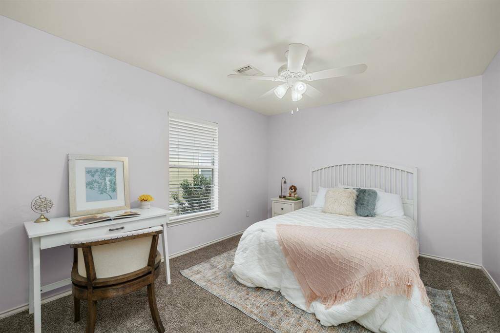 Cozy bedroom with soft pastel walls and new plush carpeting. Natural light fills the space, creating a calm and serene atmosphere.