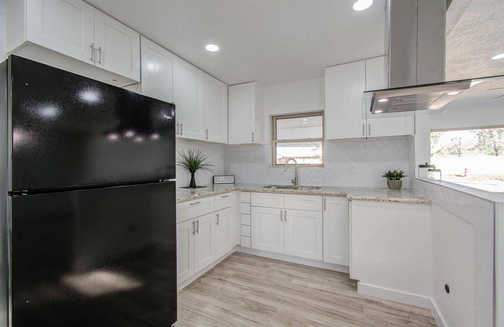 Modern kitchen with sleek countertops, ample storage, and contemporary finishes