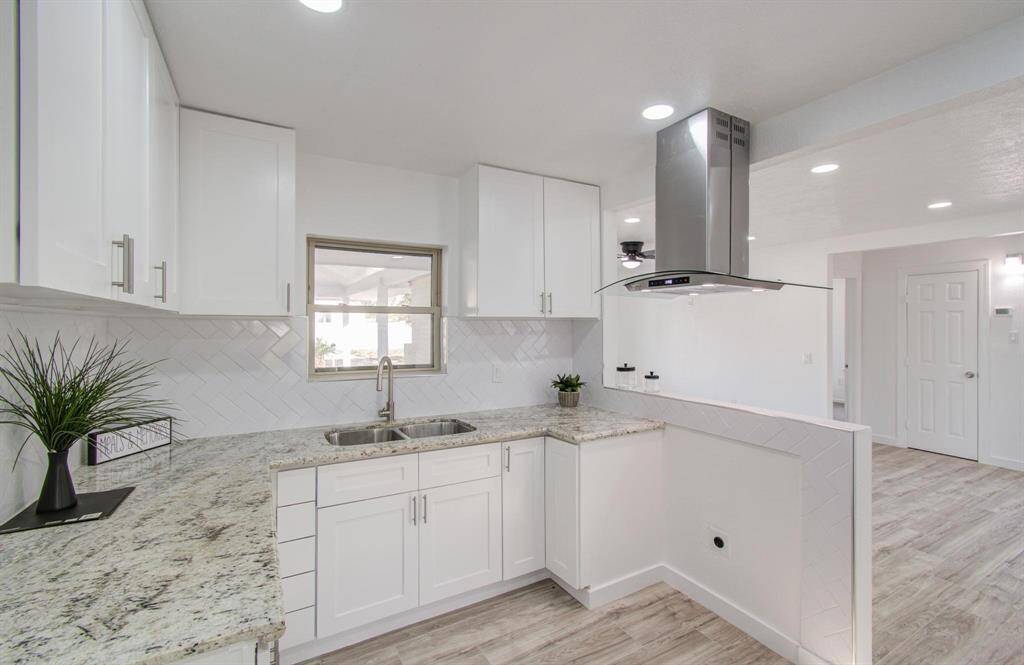 Modern kitchen with sleek countertops, ample storage, and contemporary finishes