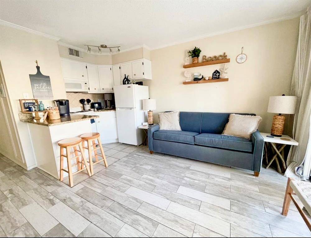 Beautifully updated condo. Look at that pretty flooring! The couch is a sleeper sofa.