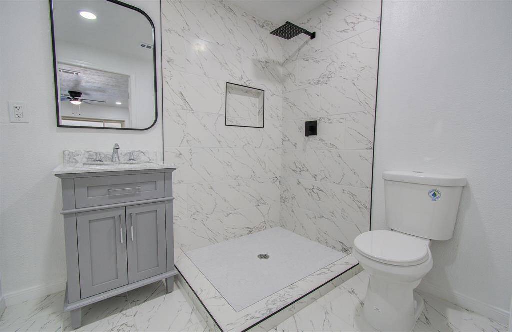 Master bathroom featuring a large vanity, walk-in shower, and modern finishes