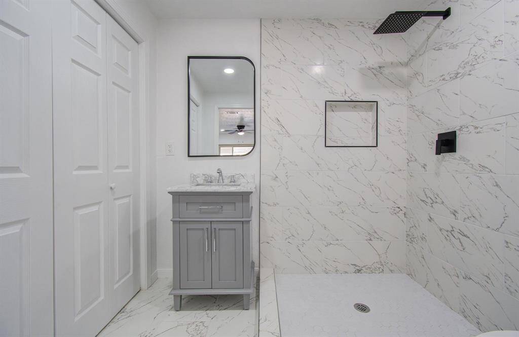 Master bathroom featuring a large vanity, walk-in shower, and modern finishes