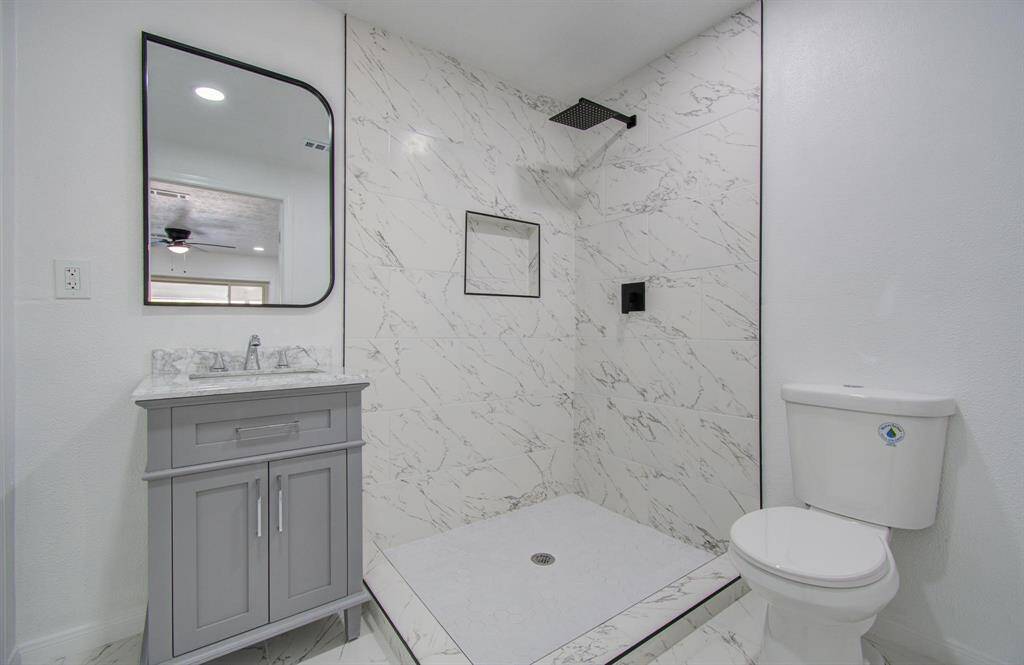 Master bathroom featuring a large vanity, walk-in shower, and modern finishes