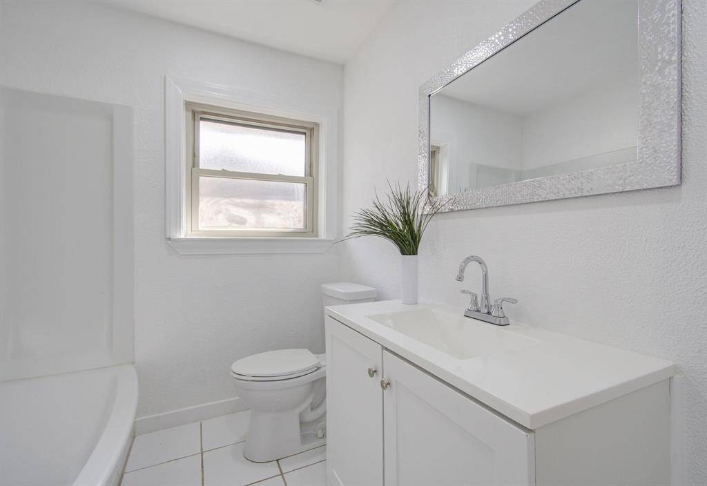 Updated second bathroom with a sleek vanity, shower, and contemporary design.