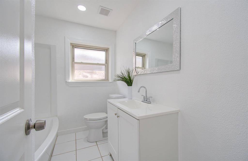 Updated second bathroom with a sleek vanity, shower, and contemporary design.