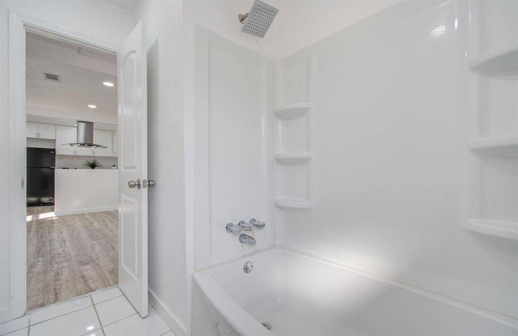 Updated second bathroom with a sleek vanity, shower, and contemporary design.