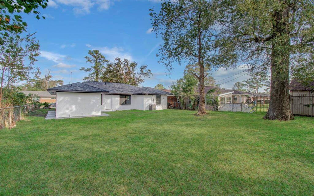 Spacious backyard with a neatly landscaped lawn and ample room for outdoor entertaining