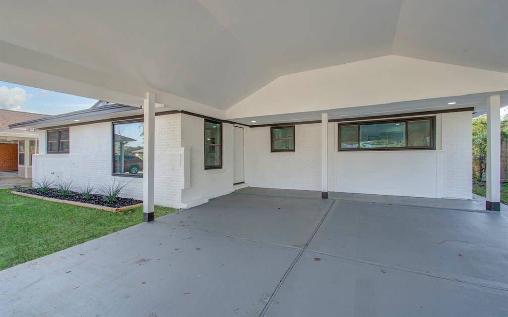 Front view featuring a spacious carport