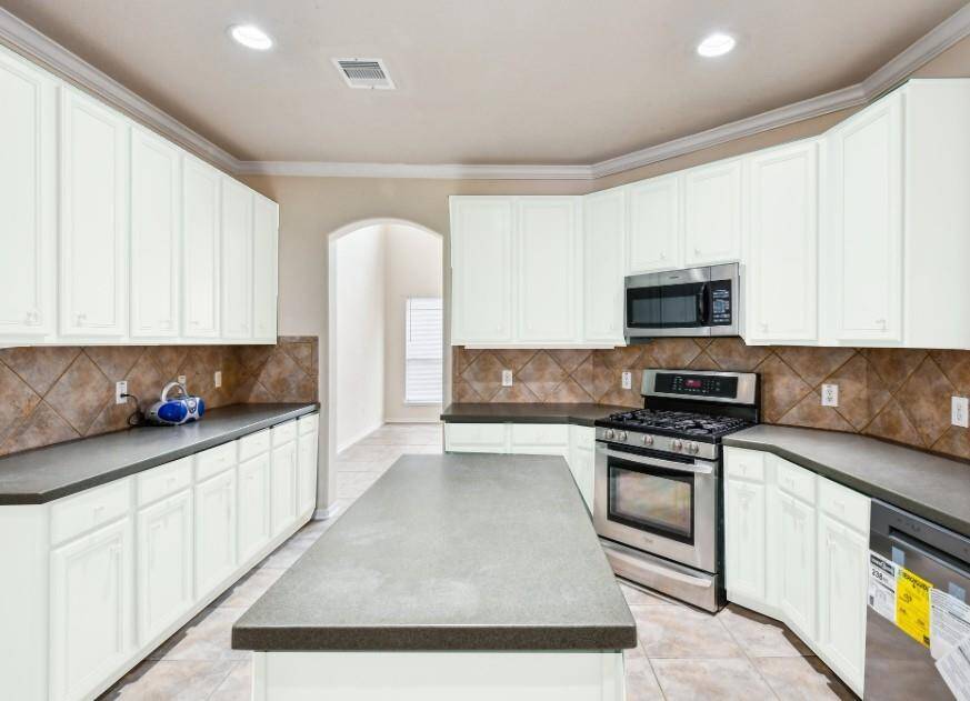 Seller is willing to paint cabinets to a color of buyer's choice before closing. This shows how cabinets would look painted white