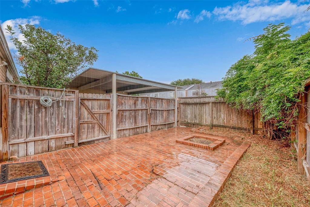 With a cozy, private backyard with a brick patio and mature flowering shrubs along the fence line, offering a quaint outdoor space for your relaxation and entertaining.