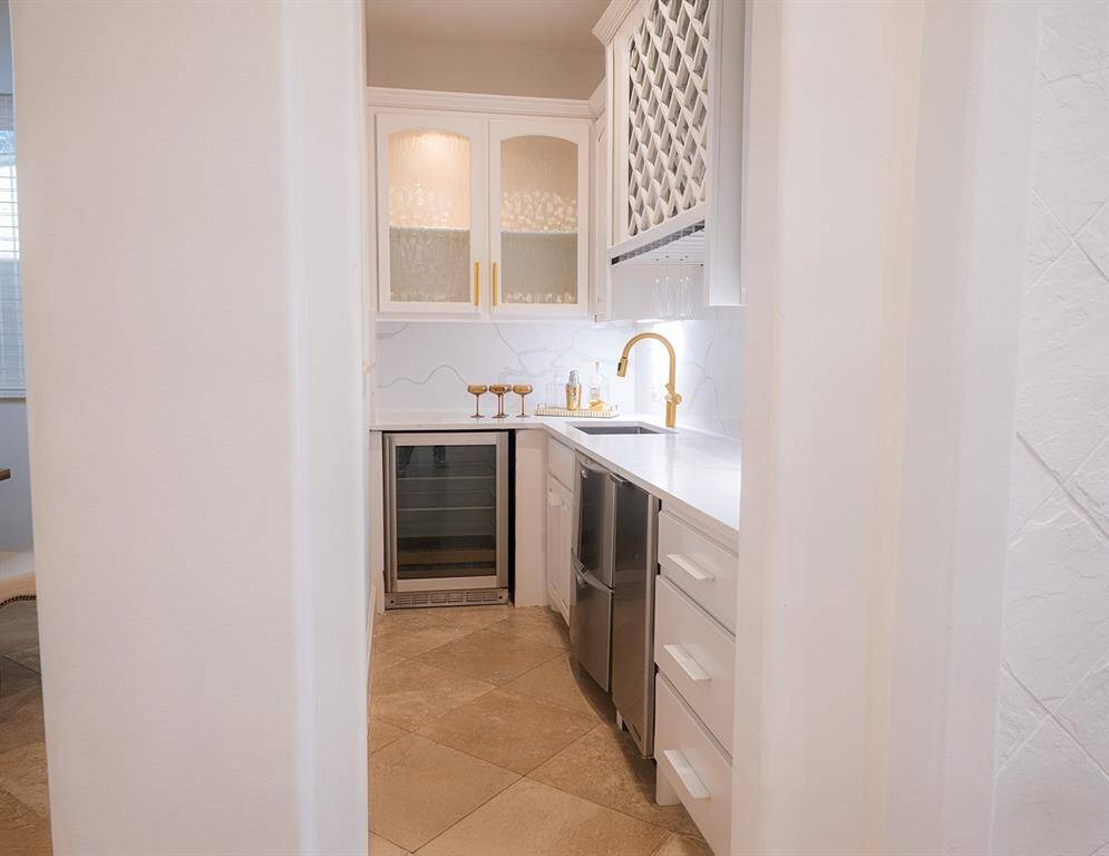 Walk-in wet bar with top-tier amenities:  dishwasher drawers, beverage frig, wine storage and ice maker.  Entertainer's delight - and if not desired, an extended pantry.