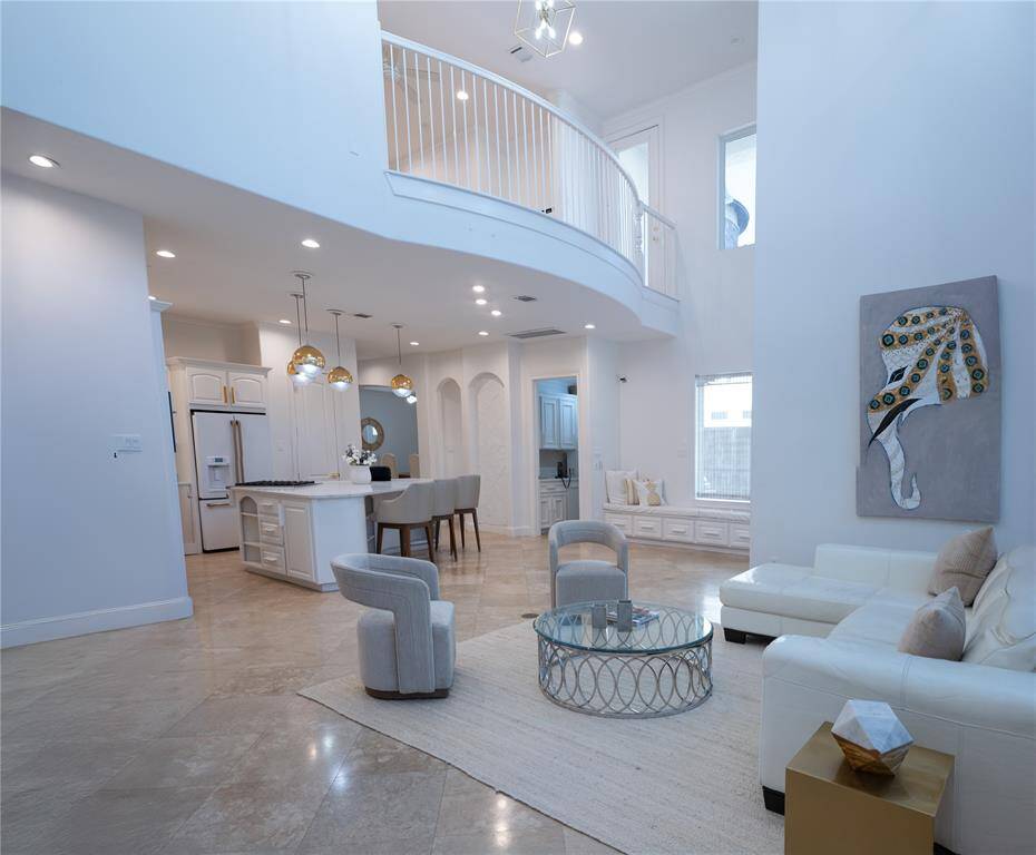View back toward kitchen shows seamless living and entertaining.  The Juliet balcony opens to the upstairs gameroom.