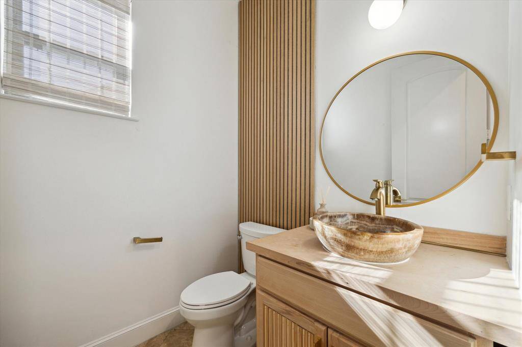 Delightful downstairs powder room, discreetly tucked off of entry.