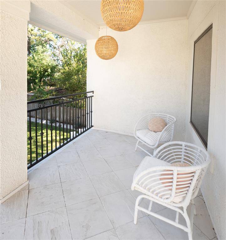 Second story balcony overlooking the backyard and community garden.