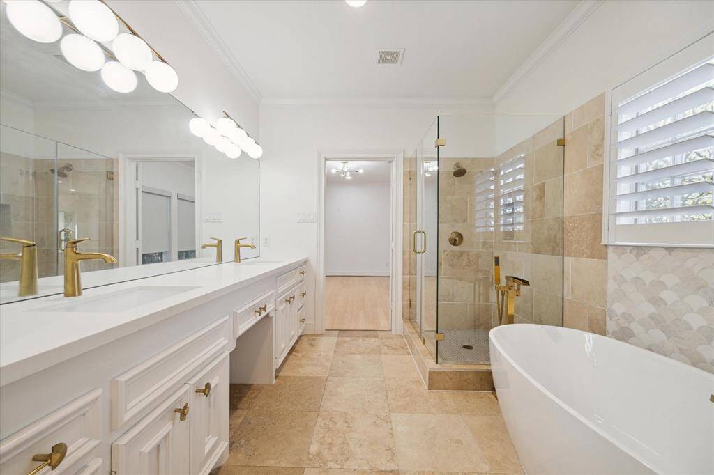 Second primary bath with walk-in shower and separate soaking tub.  Huge walk-in closet.