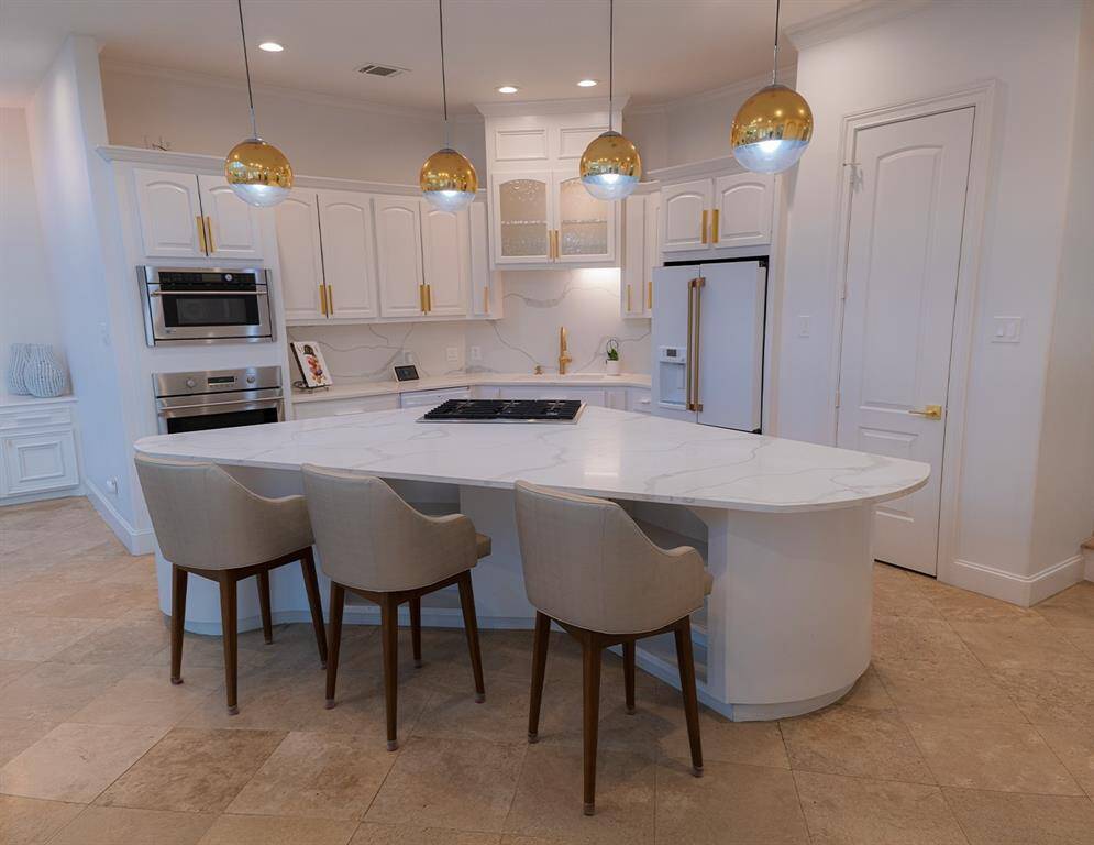 An expansive, fully renovated kitchen with quartz counters.