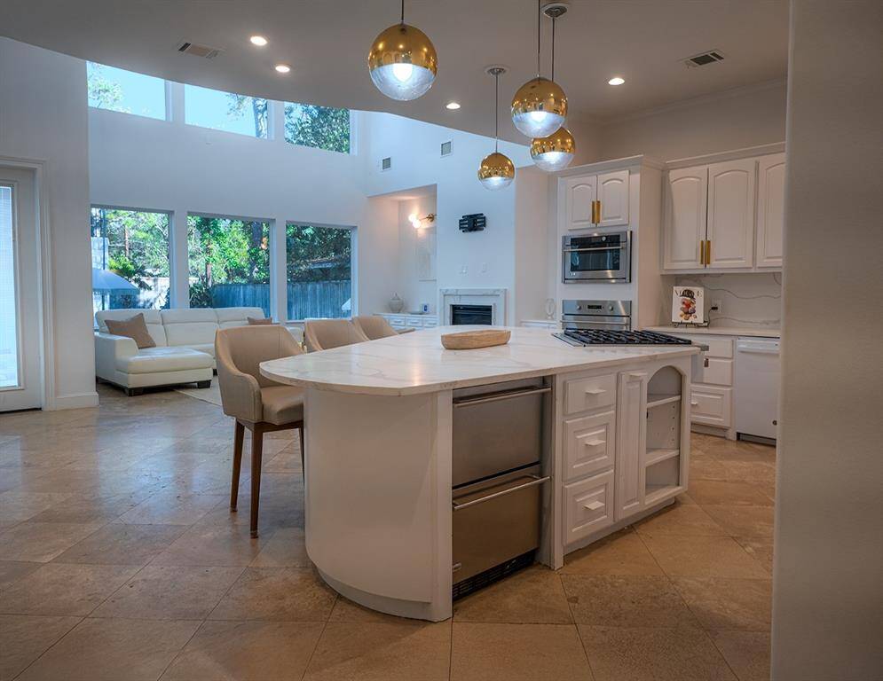 In addition to the refrigerator, two beverage drawers enhance storage and accessibility.  Adjustable shelving on both sides of the island and pull out spice racks.