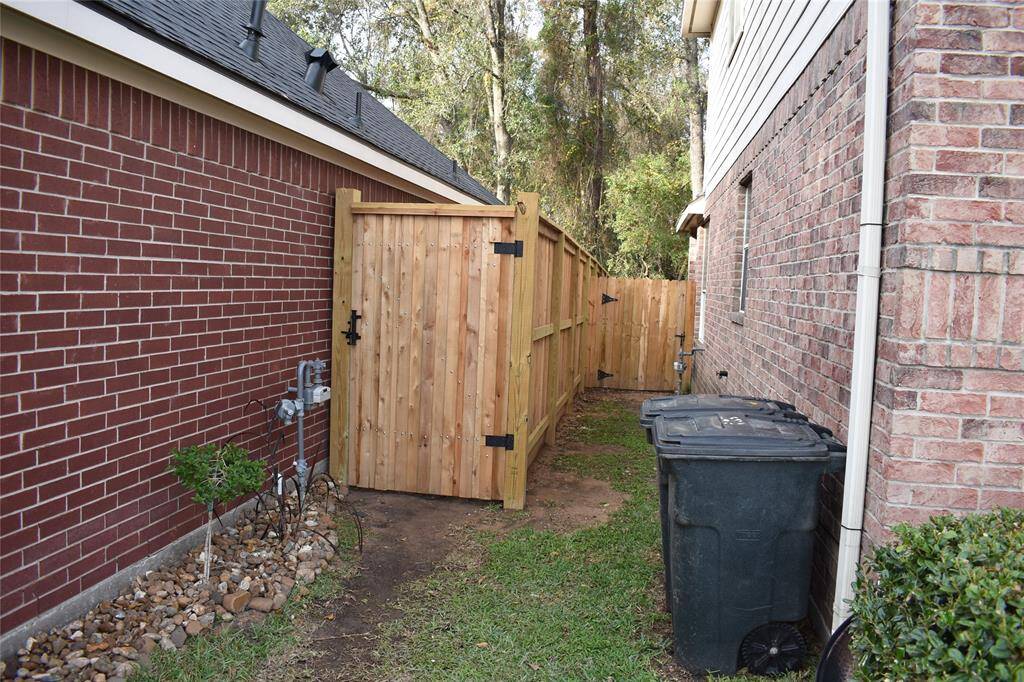 Charming side yard with a new, stylish wooden fence for added privacy and appeal.