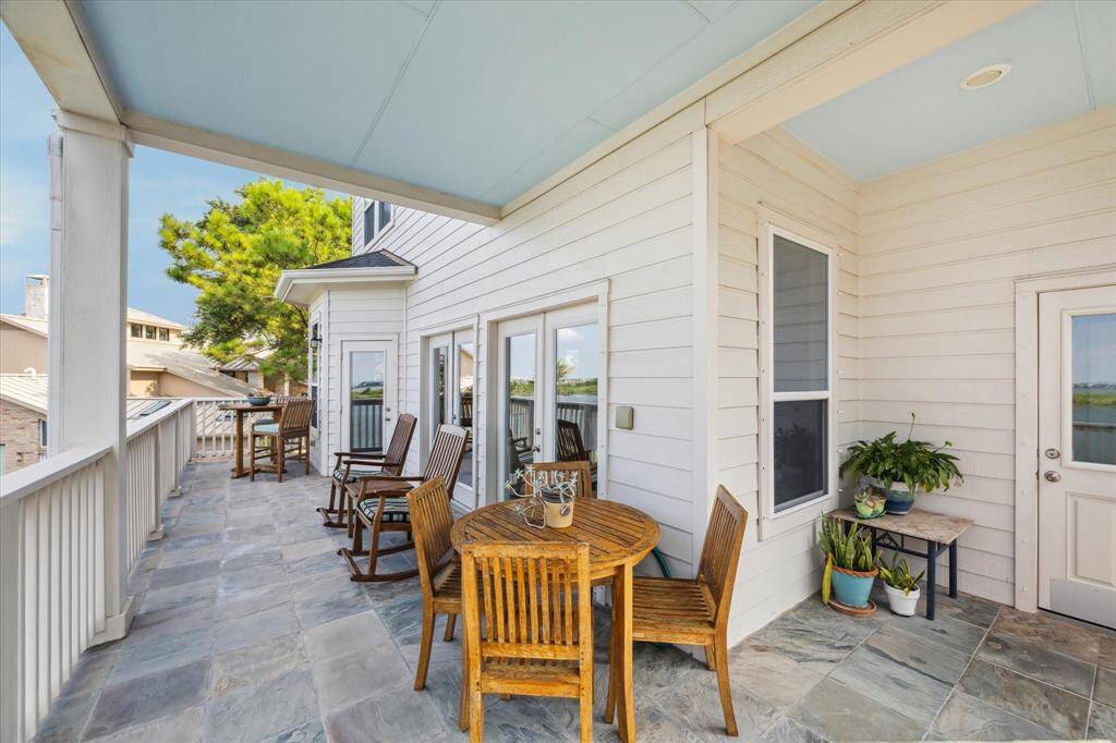 This charming balcony, accessible from the dining and living areas, offers an ideal spot to enjoy serene water views and outdoor relaxation.