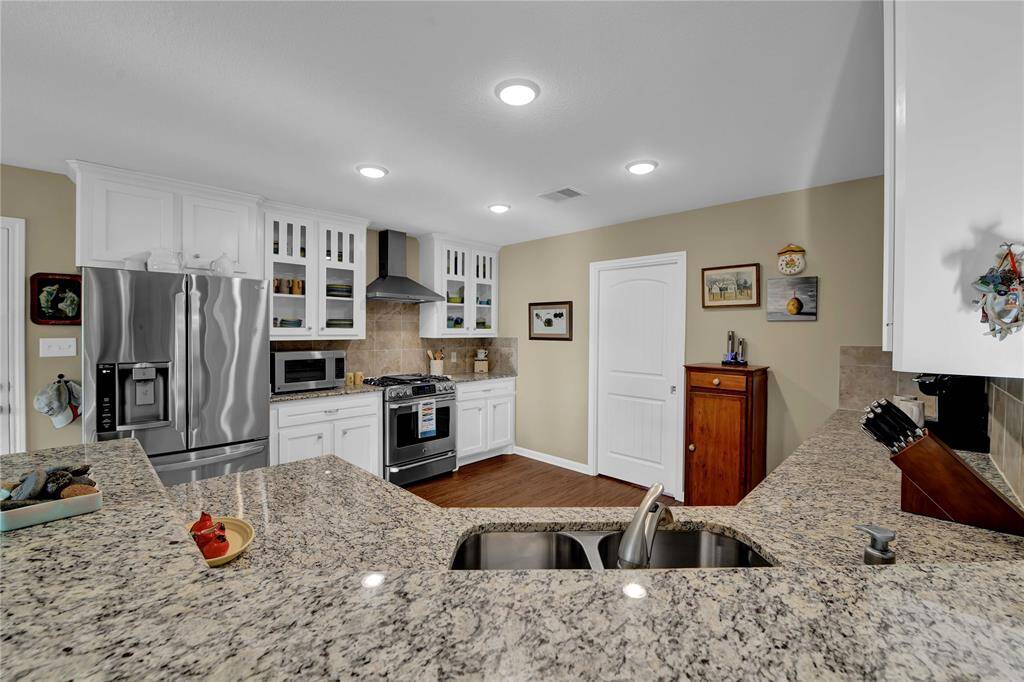Kitchen with granite countertops, beautiful cabinetry and stainless appliances.