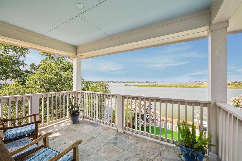 This private balcony, accessed from the primary bedroom, offers a peaceful retreat with breathtaking water views. The stone-tiled floor extends the indoor living space outdoors, providing an ideal spot for morning coffee or evening relaxation.