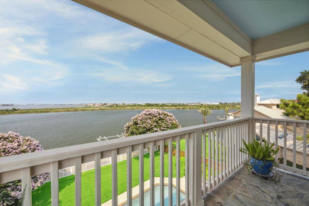 The expansive view of the water and vibrant flowers in the yard below make this private retreat a peaceful haven for quiet moments or enjoying a sunset.