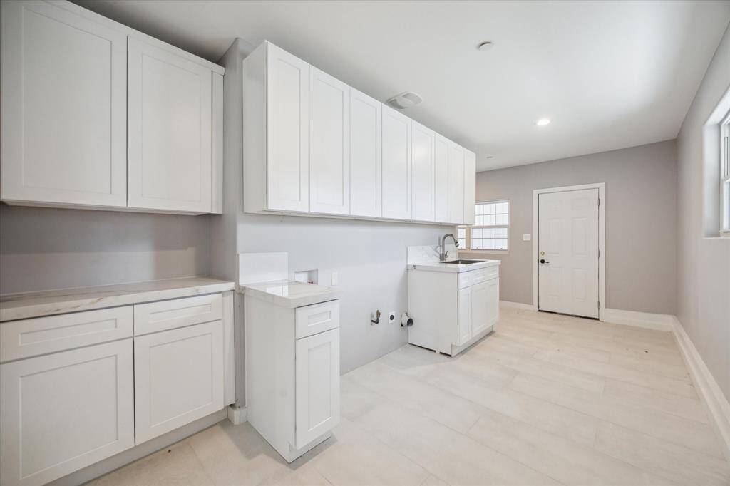 Oversized utility room right at the back door.  Perfect for mud room and and additional storage around the corner.