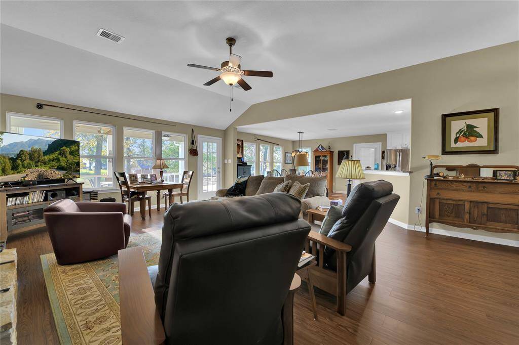 Spacious living area with wall of windows overlooking the water.