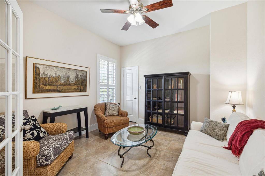 This versatile space, currently designed as a private office, features neutral tones, abundant natural light, and high ceilings. Large windows with plantation shutters add a touch of sophistication, while the French doors leading to the hallway enhance the room’s privacy. This space can easily be adapted as a fourth bedroom to suit your needs.