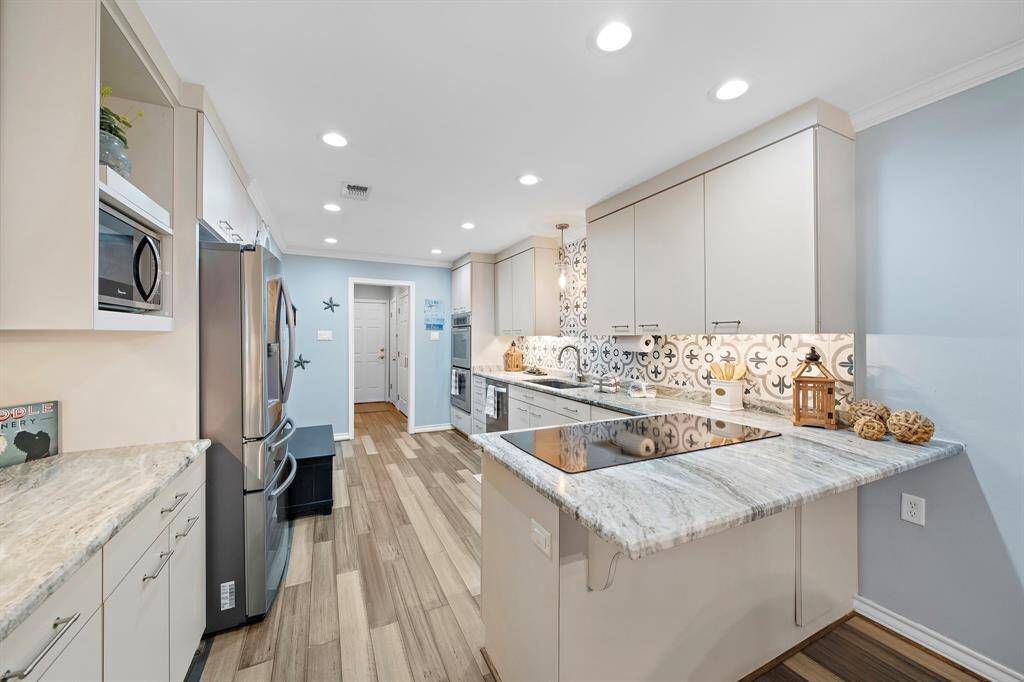 Updated Kitchen with beautiful floors, countertops and breakfast bar