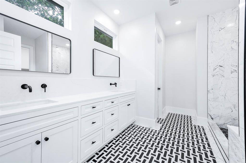 Magnificently detailed tile work in primary bathroom