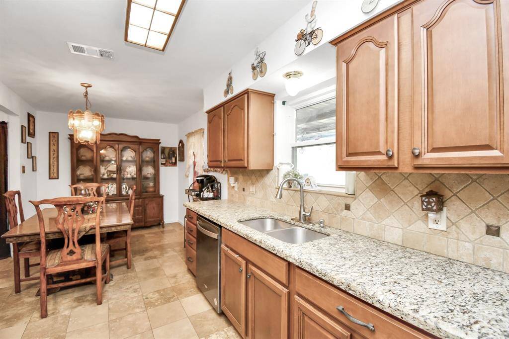 A second angle of the remodeled kitchen highlights its spacious layout and seamless flow.