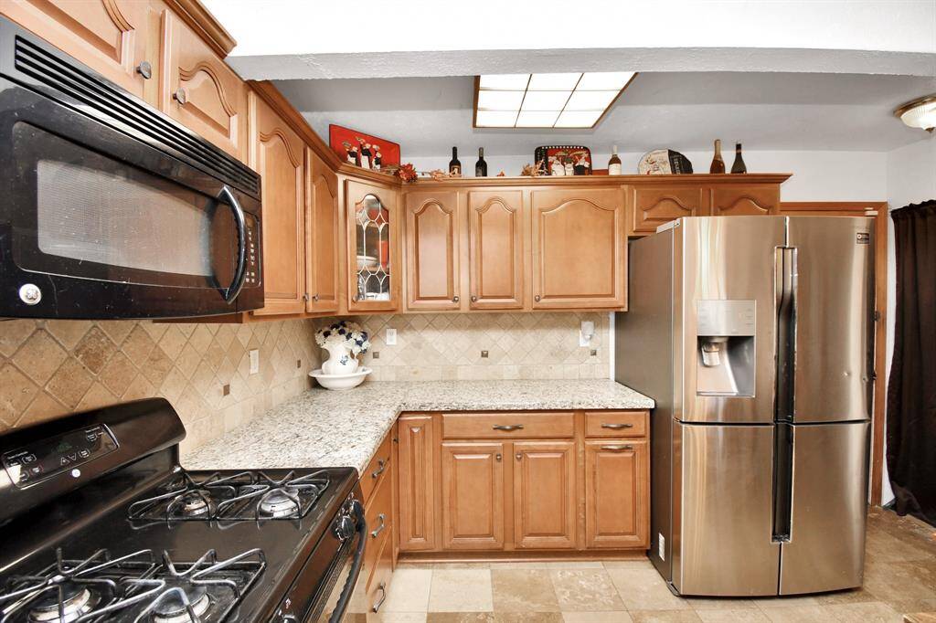 This view showcases the abundance of counter space and cabinetry, providing ample room for all your cooking and storage needs.