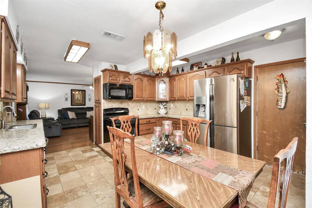 The layout feels open and airy, with easy access to both the dining area and other parts of the home. Whether you're preparing meals or enjoying a casual snack, this kitchen offers a comfortable and functional environment from every angle.