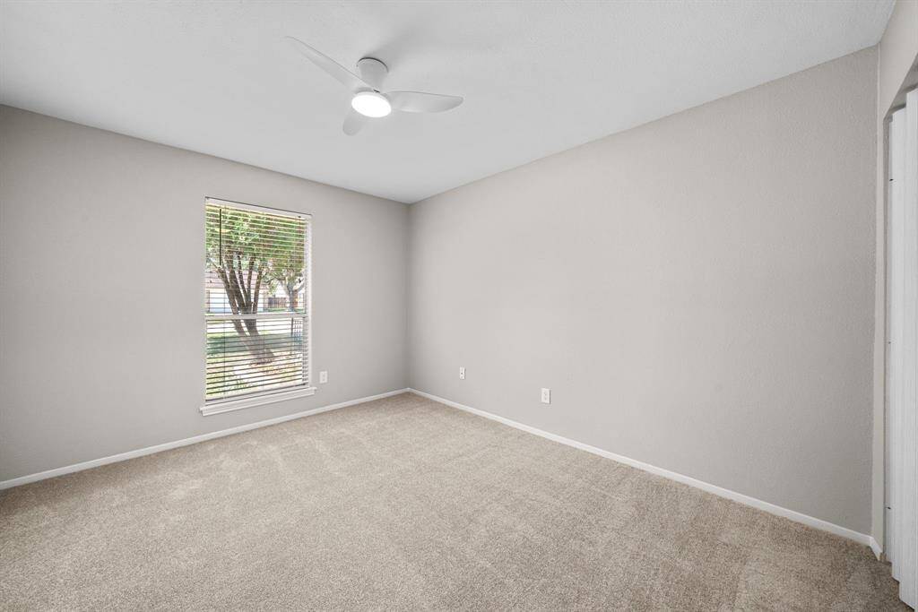 Secondary bedroom with new paint and new carpet.