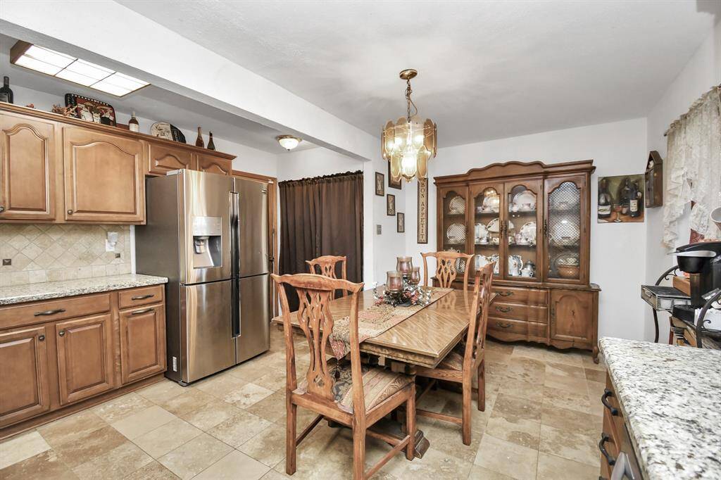 Ample space for family or friends to gather around a large dining room table.