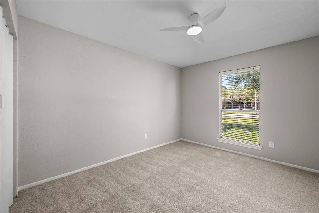 Secondary bedroom with new paint and new carpet.