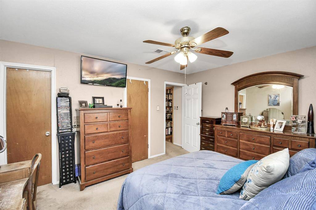 A different perspective of the primary bedroom reveals even more of its spacious layout and cozy charm. This angle emphasizes the room's generous size, offering plenty of space for furniture and personal touches.