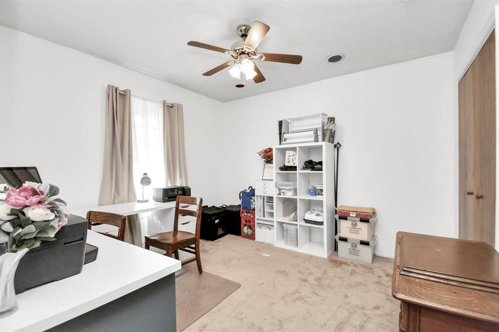 A bright and versatile second bedroom, ideal for guests, children, or a home office. The room is spacious and features large windows for natural light.