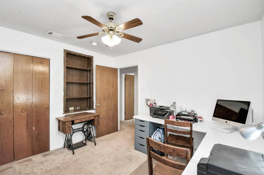 Another view of bedroom #2 showing the closet and built in bookcase.