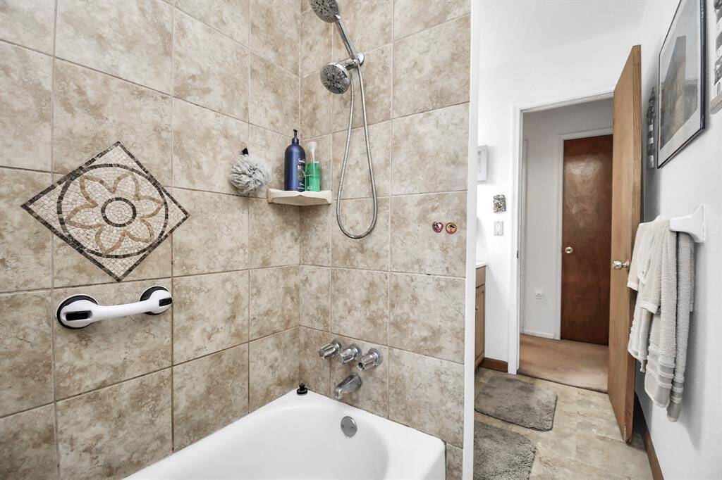 Another view of the tub/shower combo looking into the hallway. In the hallway across from the bathroom you will notice a towel closet conveniently located.