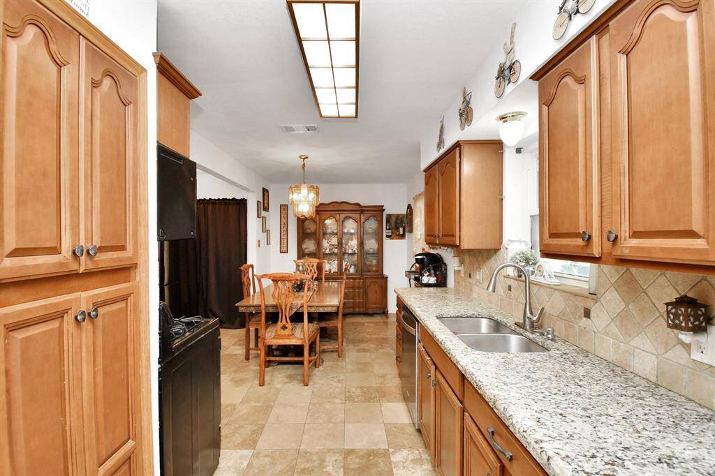 A thoughtfully remodeled kitchen that's larger than the typical galley kitchens in this neighborhood. With more counter space, extra storage, and a bright, open layout, this kitchen offers both functionality and comfort. It’s perfect for cooking, meal prep, or simply enjoying time with family and friends. The spacious design makes it feel inviting and offers plenty of room to personalize with your own style and updates.