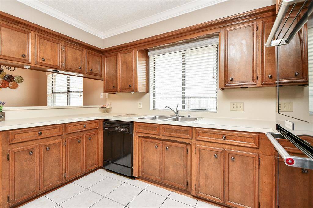 Modern kitchen with sleek black appliances and convenient double ovens.